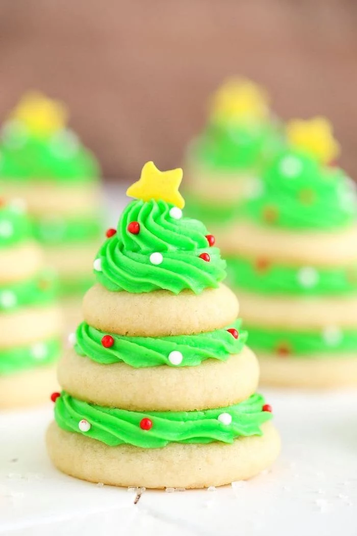 cookies stacked together with green frosting, how to make royal icing for cookies, gold star on top with sprinkles