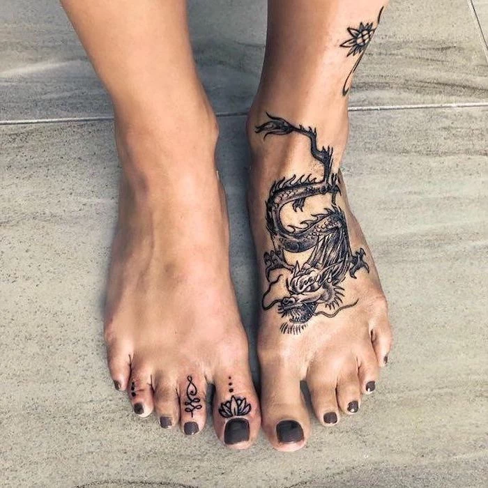 leg tattoo, woman with grey nail polish, dragon tattoo design, white tiled floor