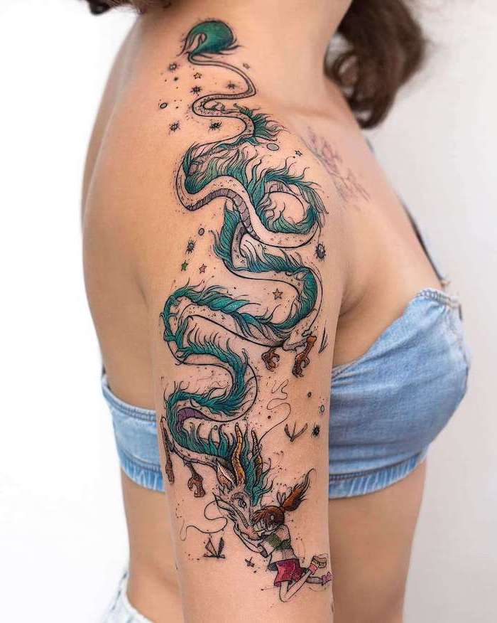 woman wearing denim crop top, arm tattoo, dragon thigh tattoo, girl petting a dragon, white background