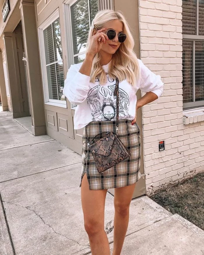 woman with blonde hair, wearing plaid skirt, fall styles for women, white blouse and snake skin print leather bag
