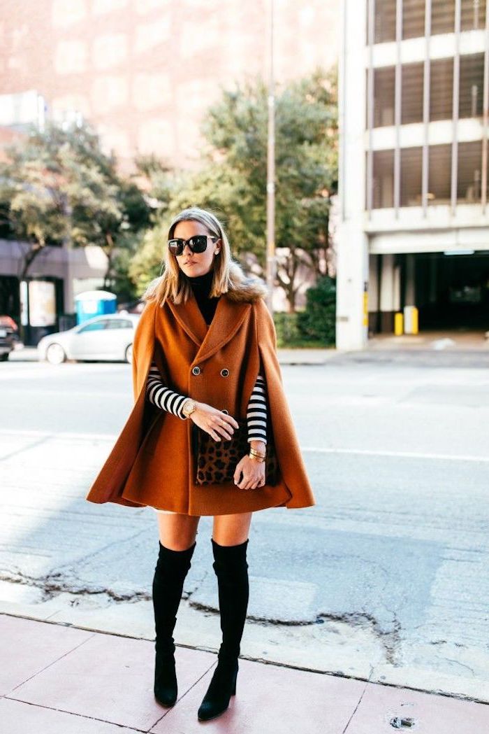 trendy fall outfits, woman standing in the middle of the street, wearing long brown coat, black velvet knee high boots