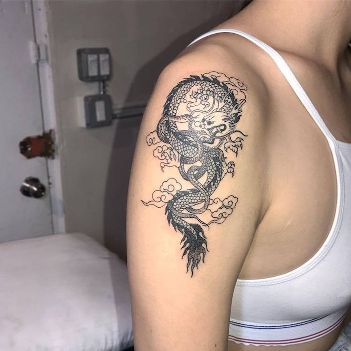 woman wearing white crop top, dragon tattoo ideas, shoulder tattoo, dragon intertwined with snake