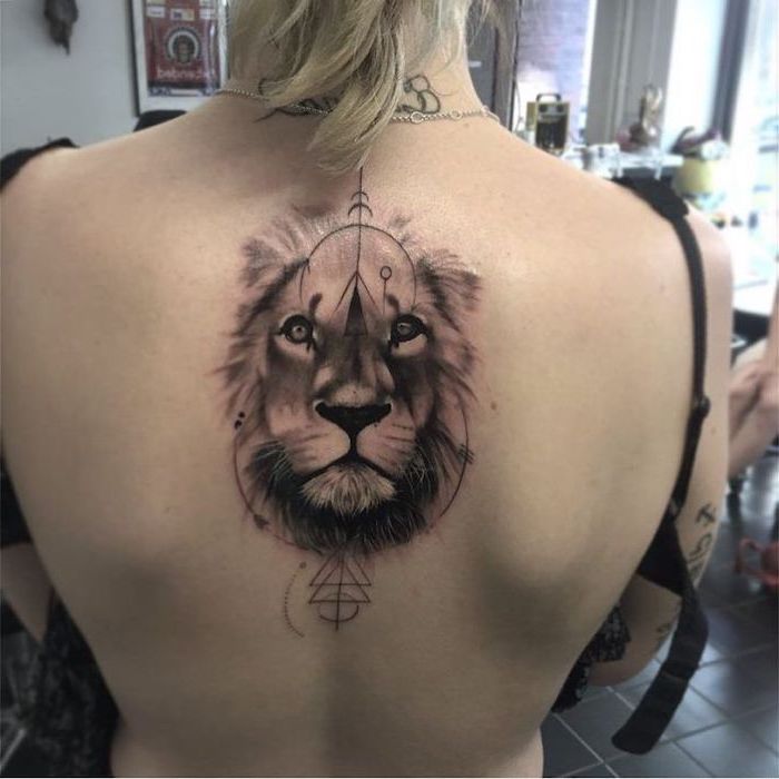 back tattoo, lioness tattoo, lion head with mane, on woman with blonde hair, geometrical design