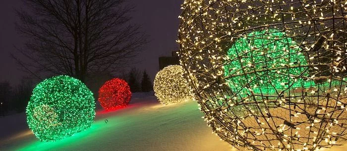large baubles made of chicken wire, outdoor christmas decorations, lights in different colors intertwined with the wire