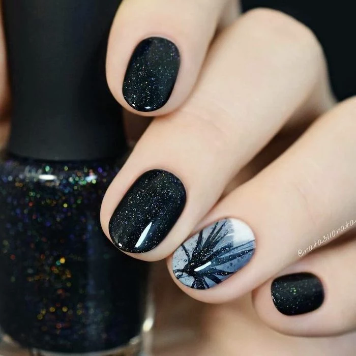 black glitter nail polish on short squoval nails, winter nail colors, grey and black decoration on the ring finger