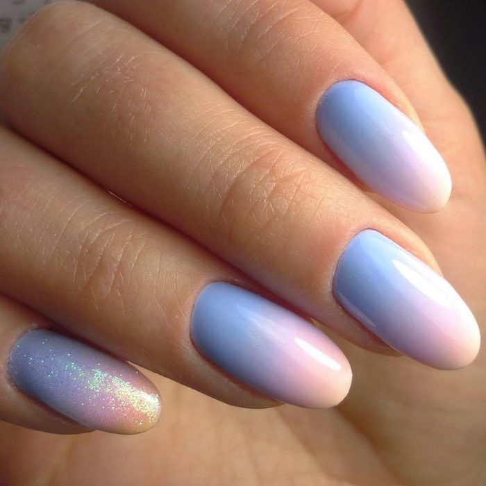 blue to pink gradient nail polish, ombre acrylic nails, glitter ombre on the pinky finger, medium length almond nails