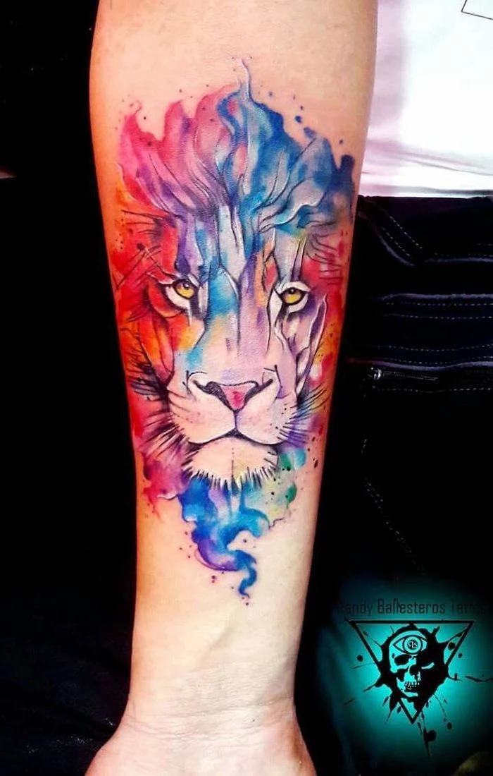 watercolor forearm tattoo, lion forearm tattoo, lion head in blue pink red purple and green, different colors