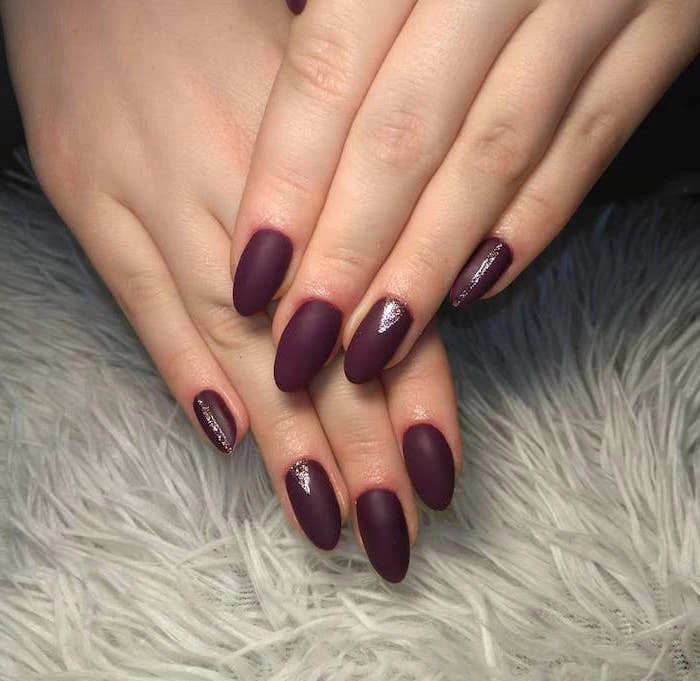 dark burgundy nail polish, neutral nail colors, long almond nails, silver glitter decorations on pinky and ring finger