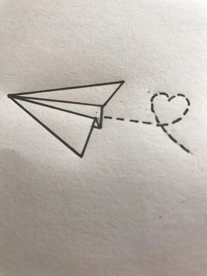 cute things to draw, flying paper plane, leaving a heart shaped trace behind it, black and white pencil sketch