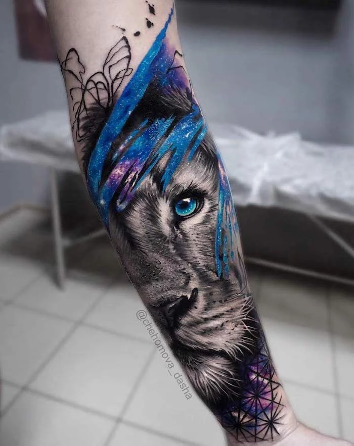 lion head with blue eyes, surrounded by galaxy, watercolor forearm tattoo, lion chest tattoo, blurred background