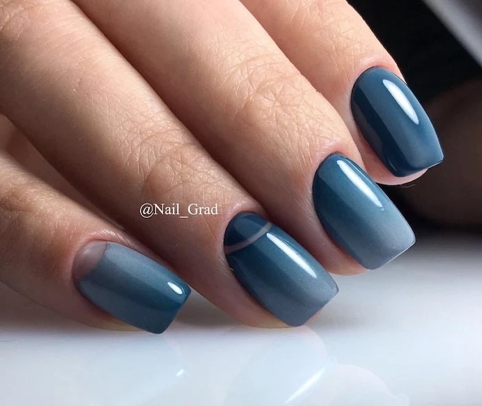 winter nails, gradient shades of blue nail polish, short squoval nails, hand placed on white surface