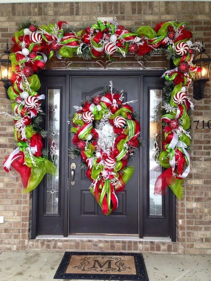wreaths made of green and red ribbons and baubles, hanging on door and door frame, front porch christmas decorations