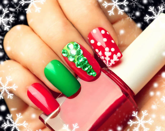 green and red nail polish, pretty nail colors, green rhinestones christmas tree on middle finger, snowflakes on index finger