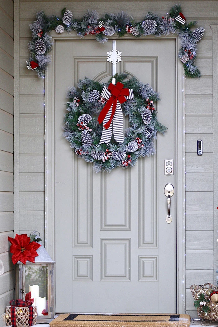 diy outdoor christmas decorations, wreaths with snowy pinecones and red ribbon, hanging over door and door frame