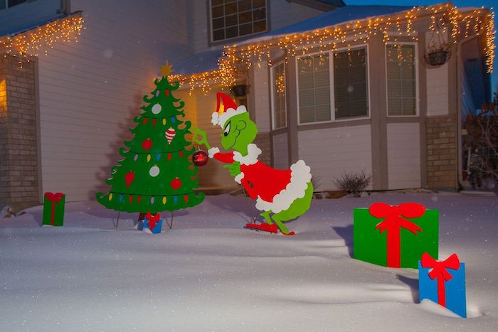 grinch christmas tree and presents, made of carton, placed on the snow, in front of a house, diy outdoor christmas decorations