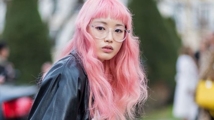 woman wearing glasses, black leather jacket, brunette highlights, long pink wavy hair with highlights