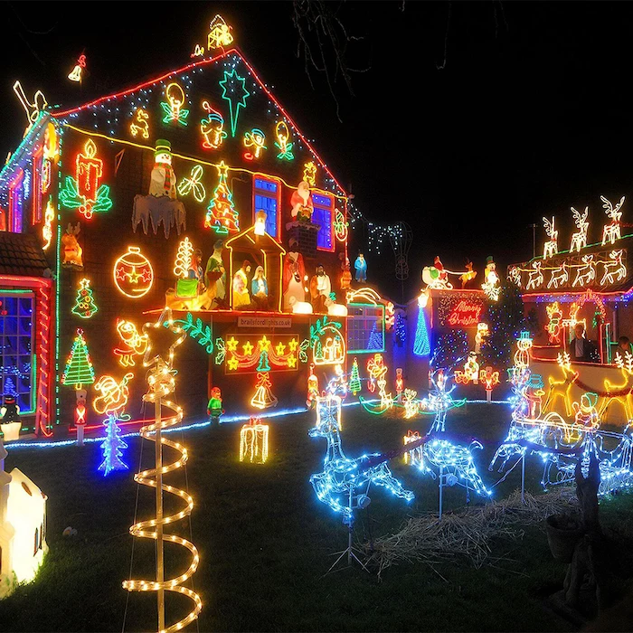 front door christmas decor, large two storey house, covered with lighted figures, lighted figurines in the back yard