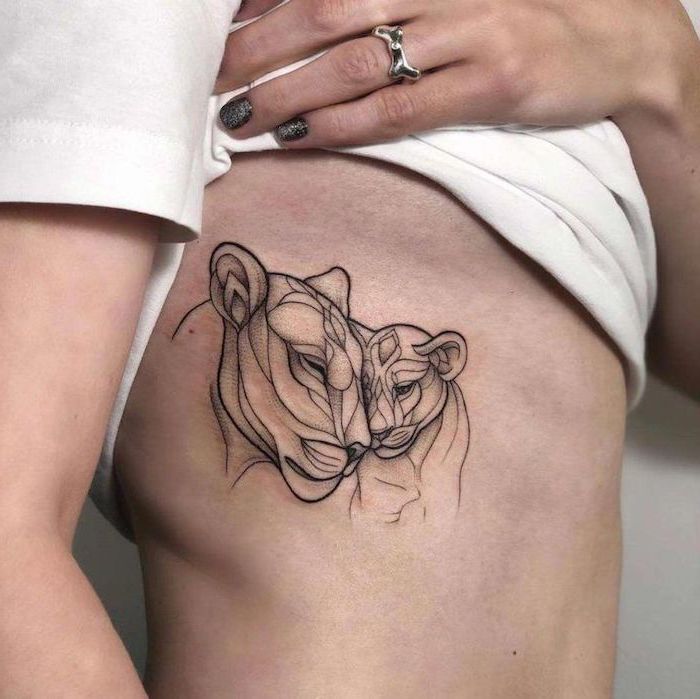 lioness with her cub, tattoo on the side of the rib cage, on woman wearing white t shirt, lion king tattoo