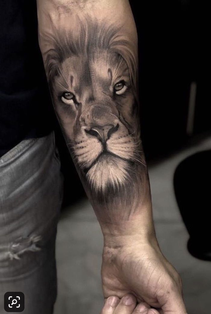 Lion Shoulder Tattoos For Men   Lion Head Forearm Tattoo Lion King Tattoo On Man Wearing Jeans And Black T Shirt 