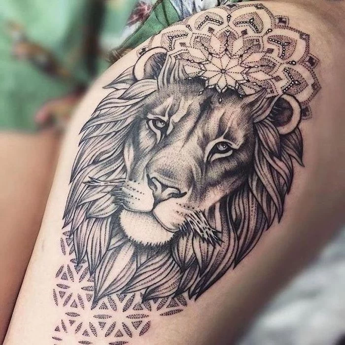 lion head with mandala flowers, lion king tattoo, thigh tattoo, blurred background