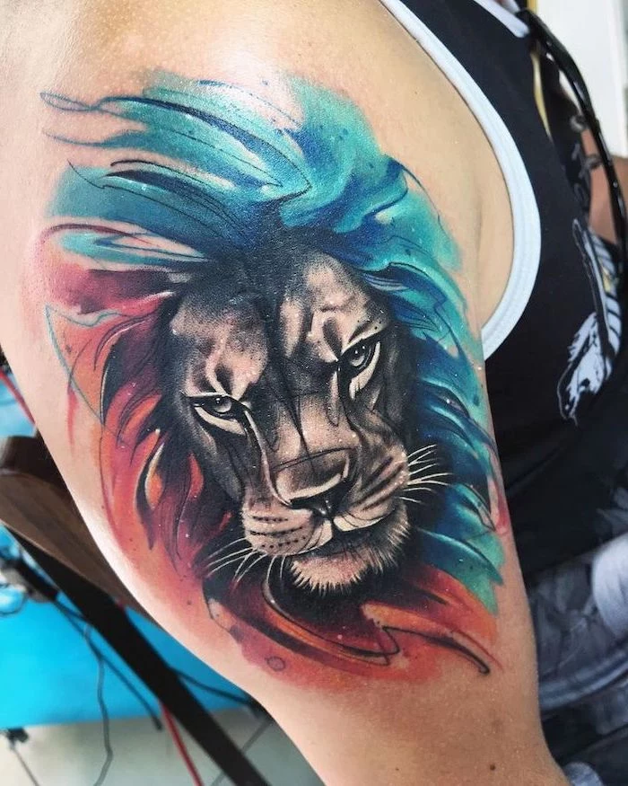 lion sleeve tattoo, watercolor shoulder tattoo, angry lion with mane, colored in blue and red
