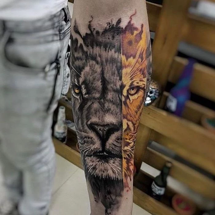 lion head, one half in black and white, other half in yellow and orange, lion sleeve tattoo, forearm tattoo