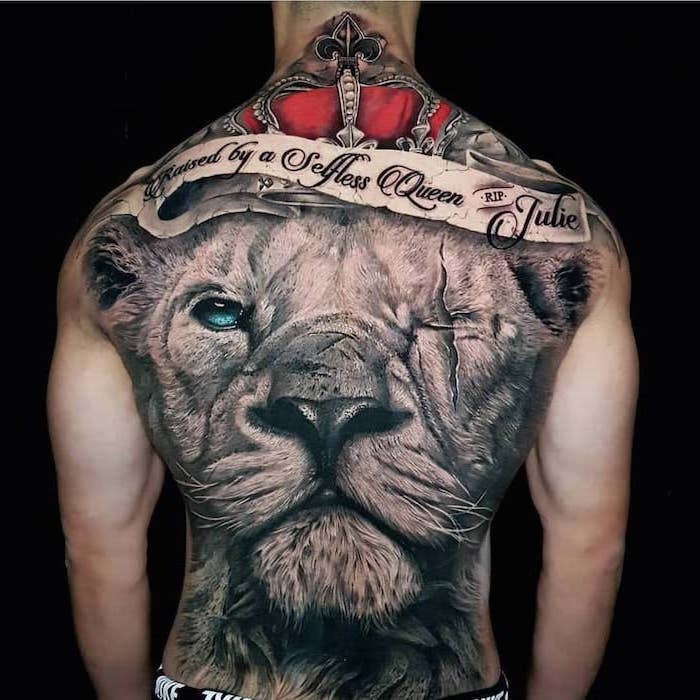 large back tattoo, lion sleeve tattoo, lion with one blue and one scarred eye, red crown on its head