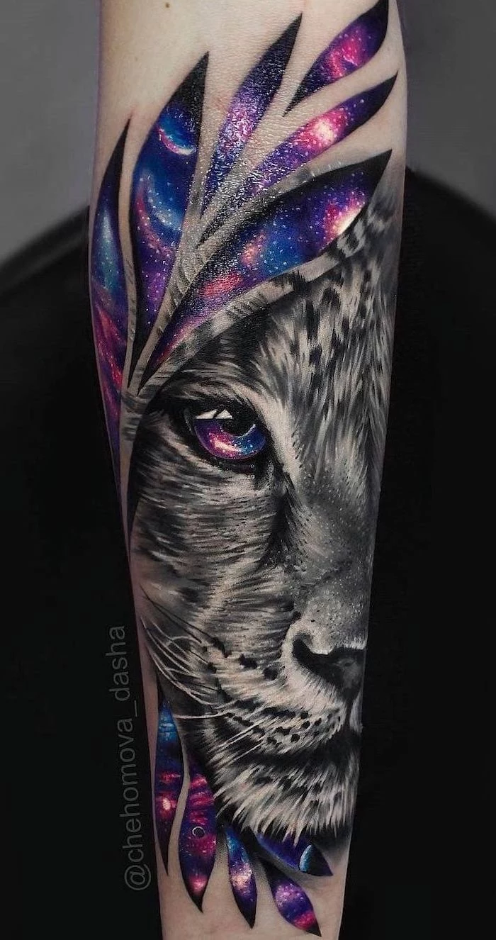 lioness head, surrounded by watercolor galaxy, forearm tattoo, lion with crown tattoo