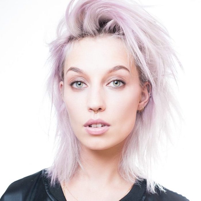 curly hair color ideas, shoulder length straight bob, woman with light purple hair, wearing black shirt