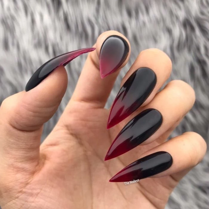 black to red gradient nail polish, extra long stiletto nails, blue ombre nails, blurred background