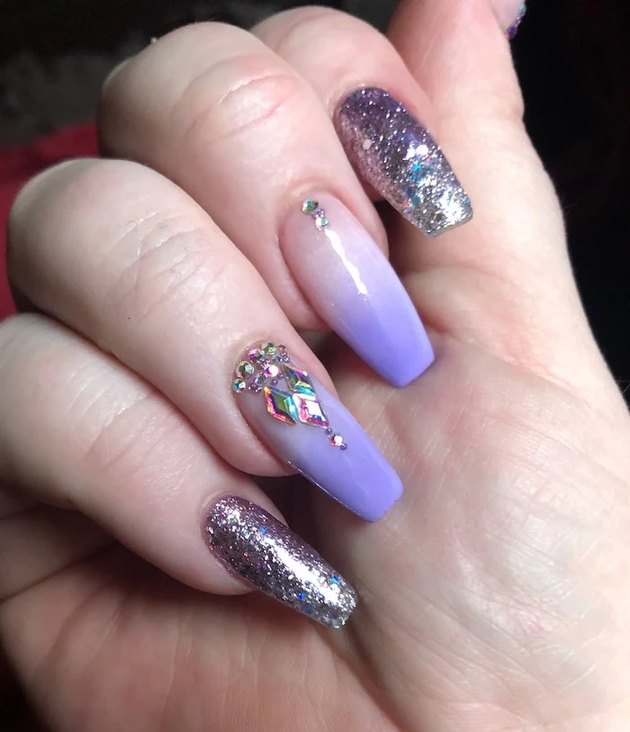 nude to purple gradient nail polish, ombre nail designs, purple glitter nail polish on index and pinky, rhinestones decorations
