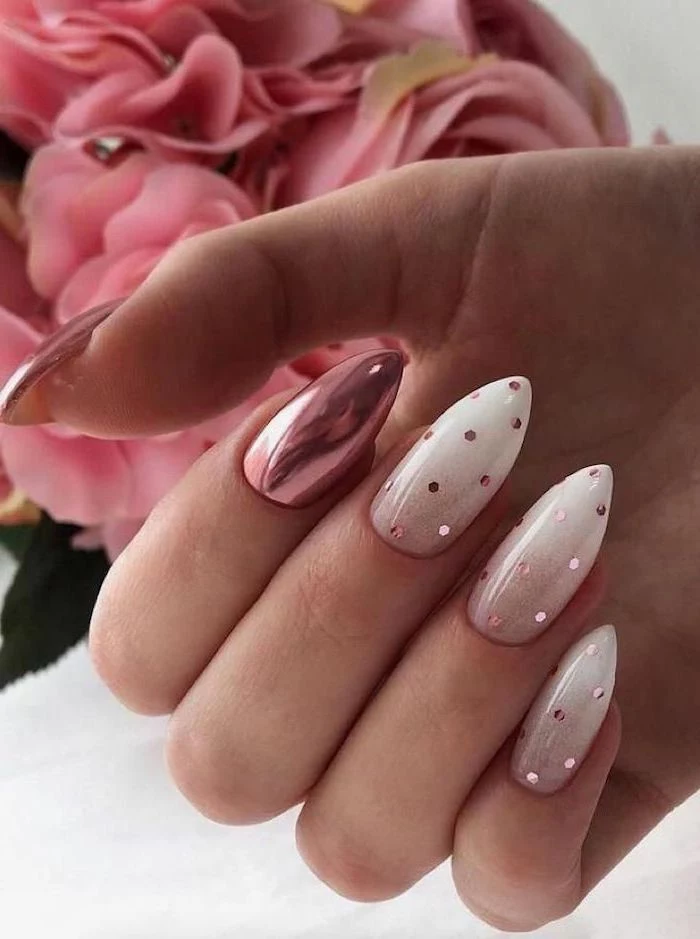 nude to white gradient nail polish, metallic rose gold nail polish on thumb and ring finger, red ombre nails, rose gold decorations