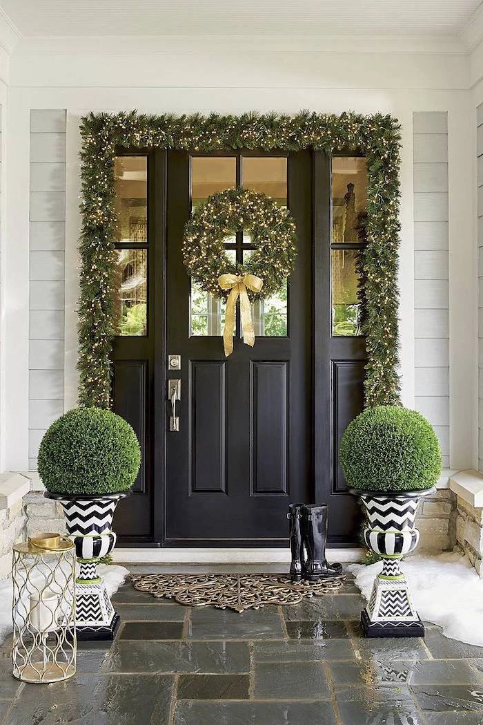 wreaths with lights, hanging over door and door frame, grinch outdoor christmas decorations, bushes on both sides