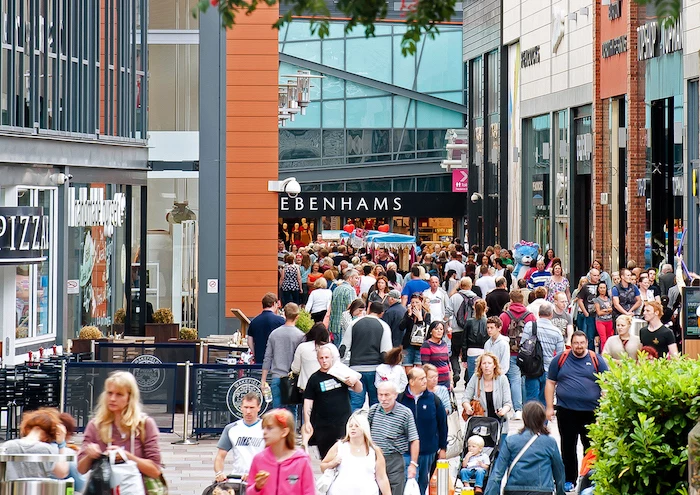 people walking up and down the street, benefits of shopping, high street, shops on both sides