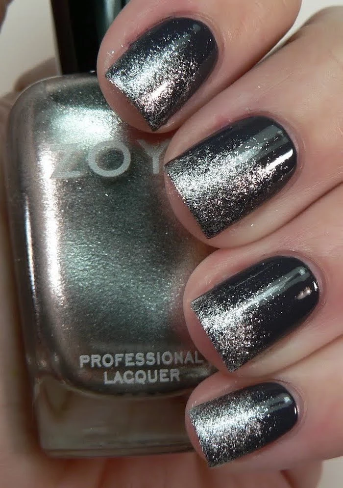 black to gold glitter gradient nail polish, short square nails, blue ombre nails, hand holding a nail polish bottle