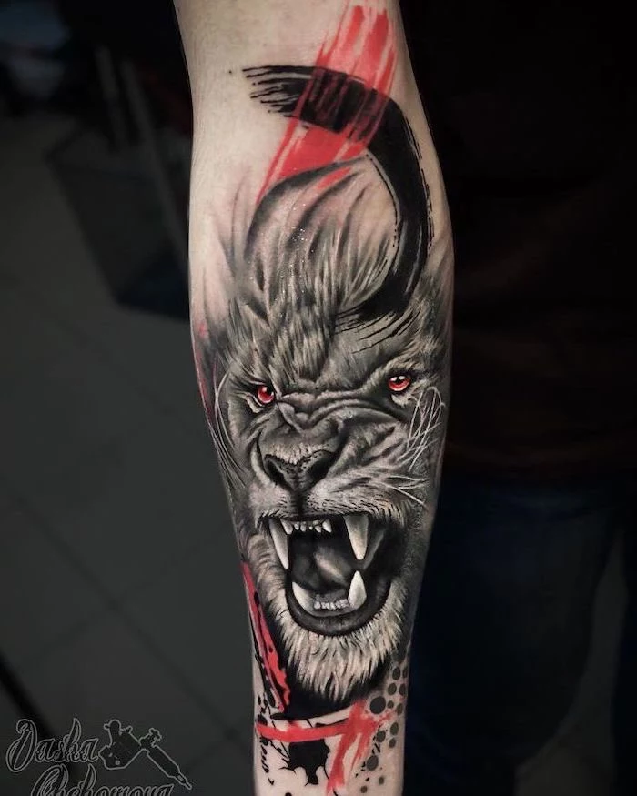 trash polka tattoo, tribal lion tattoo, forearm tattoo, roaring lion with red and black brush strokes around it