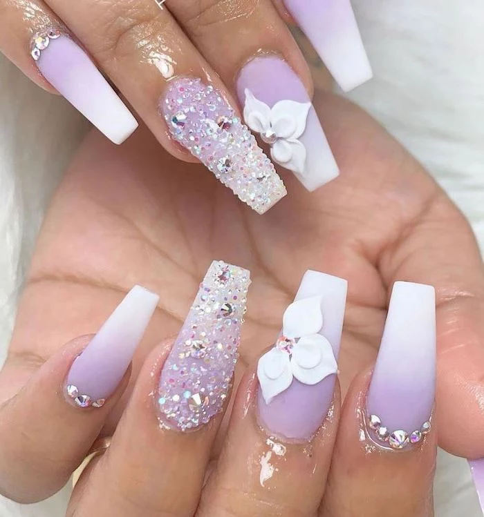 purple to white gradient matte nail polish, rhinestones and decorations on each nail, french fade nails, long coffin nails