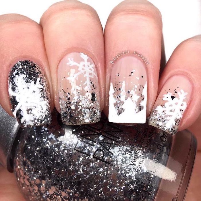 silver glitter nail polish, christmas nail colors, snowflake decorations on each nail, hand holding a nail polish bottle