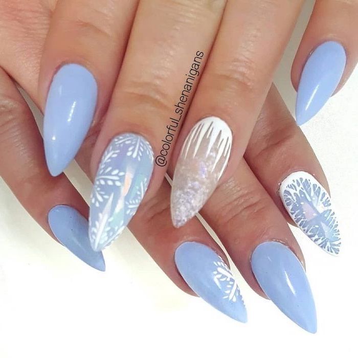 blue and white nail polish, winter nail ideas, long stiletto nails, snowflakes and ice decorations on different fingers