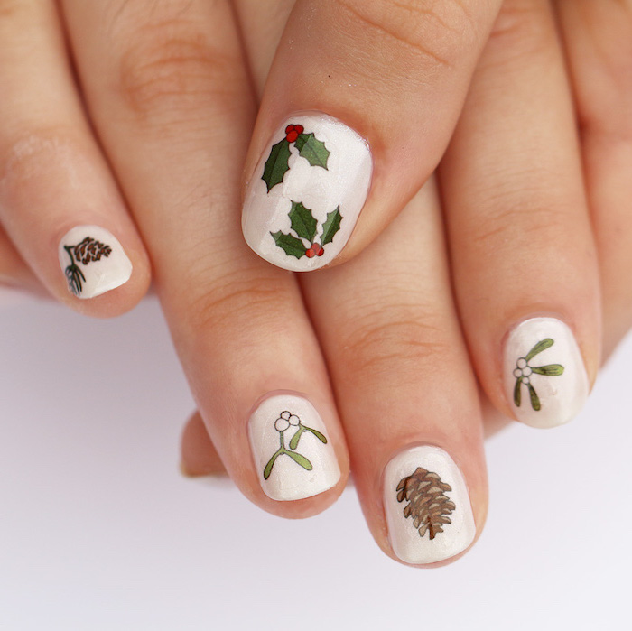 january nail colors, white nail polish, short squoval nails, different christmas themed decorations on each nail