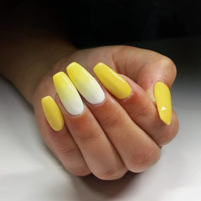 white to yellow gradient nail polish, on middle and ring fingers, how to do ombre nails, yellow nail polish on the rest of the fingers