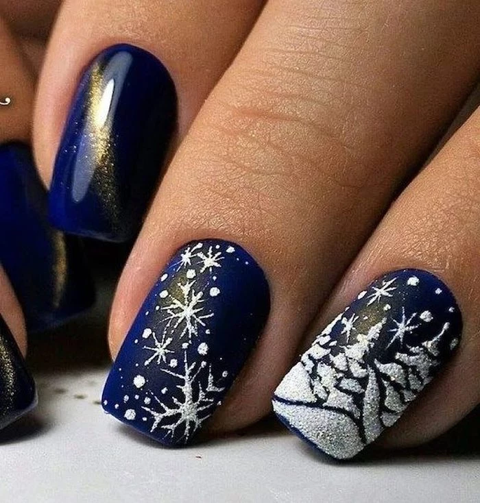 blue metallic nail polish, cute winter nails, white christmas themed decorations on middle and ring fingers
