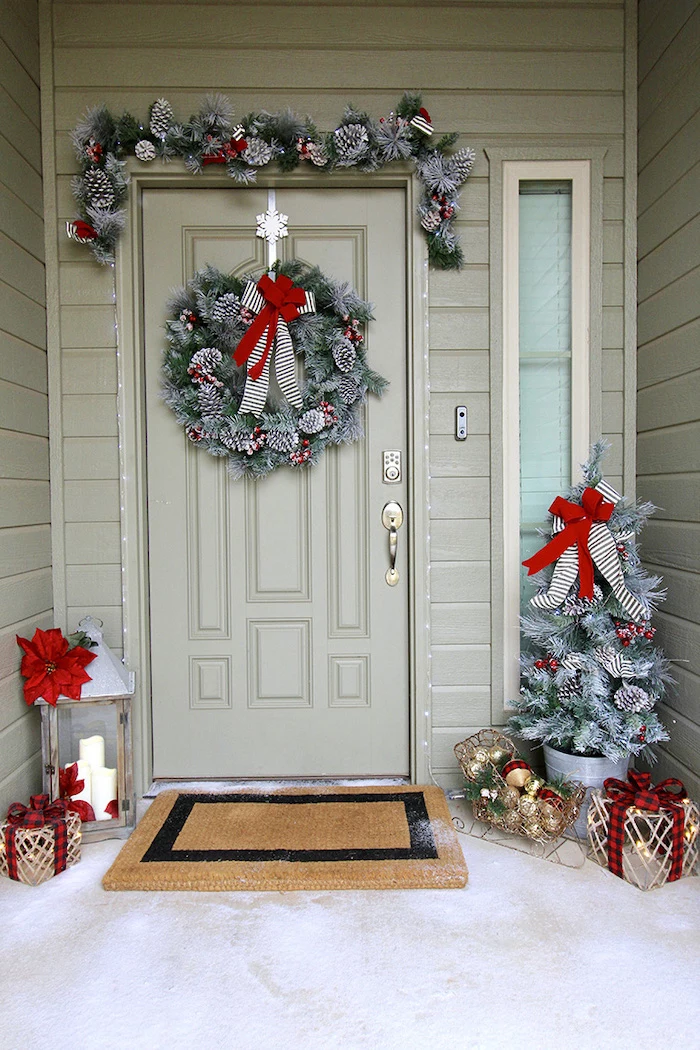wreaths with pinecones, hanging on the door and door frame, large outdoor christmas decorations, decorated christmas tree in the corner