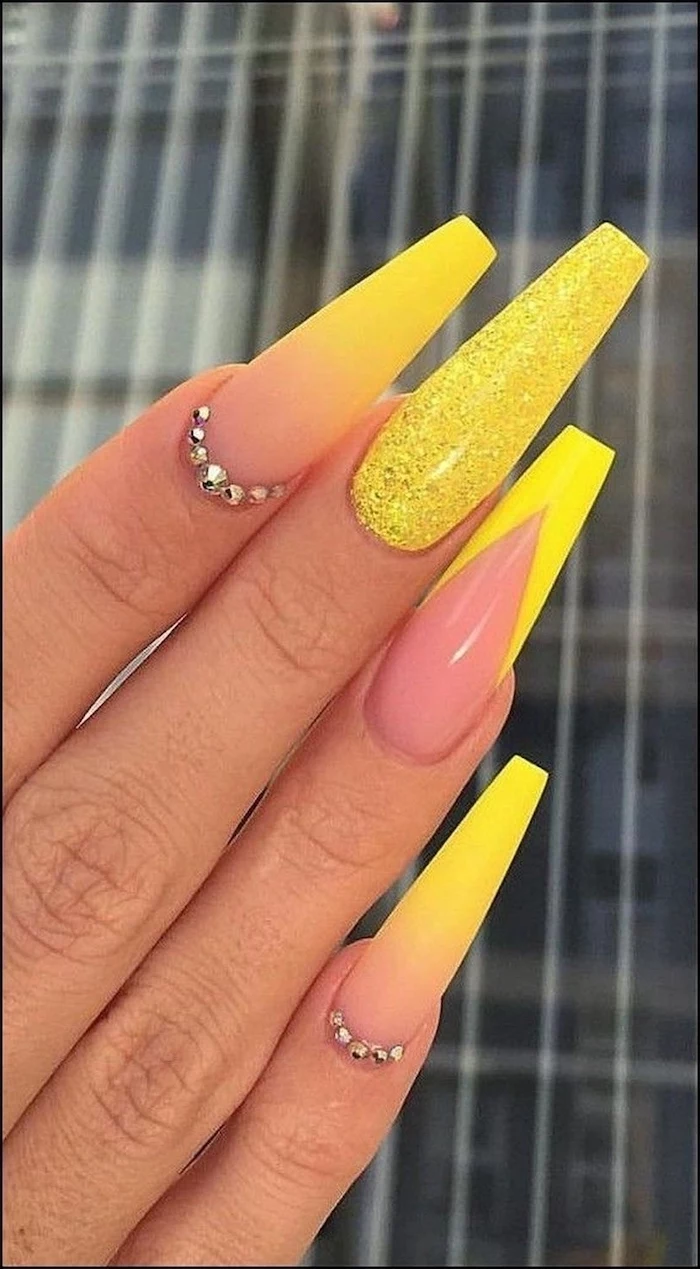 nude to yellow gradient matte nail polish, rhinestones decorations, yellow glitter, how to do ombre nails, extra long coffin nails