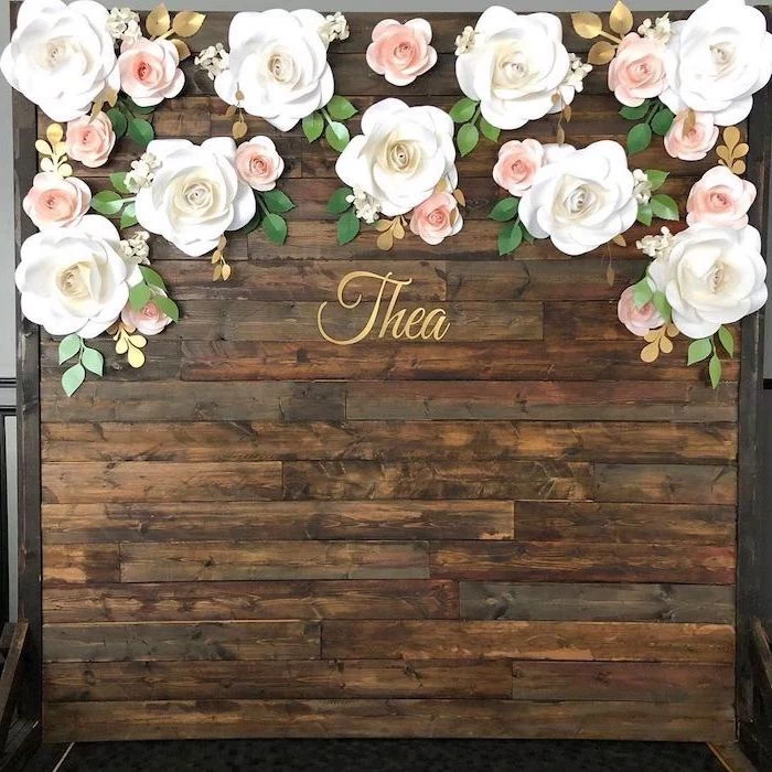 large backdrop made of wooden boards, paper flower templates, large white paper roses, arranged on the top