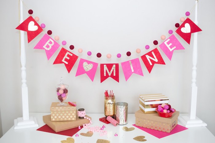be mine banner in red and pink, hanging over white table, valentine decorations ideas, carton boxes and hearts on it