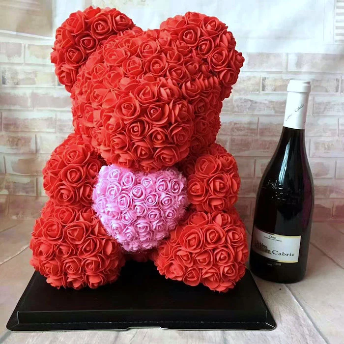 bear made of pink and red roses, holding a heart, valentine gift ideas, champagne bottle on the side