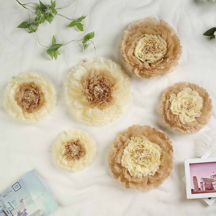 flowers made of different shades of beige tissue paper, paper flower templates, arranged on a white surface