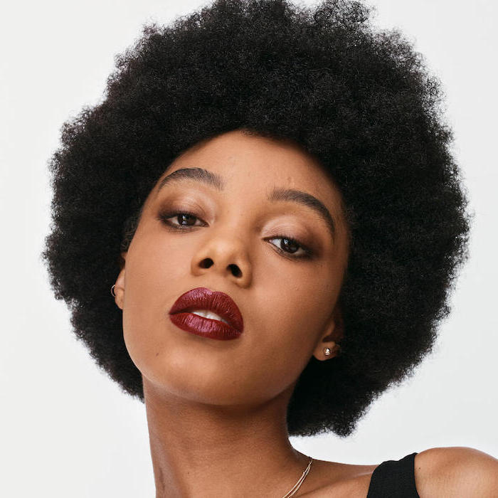 woman with curly black hair, how to apply eyeshadow, wearing nude eyeshadow colors, dark red lipstick