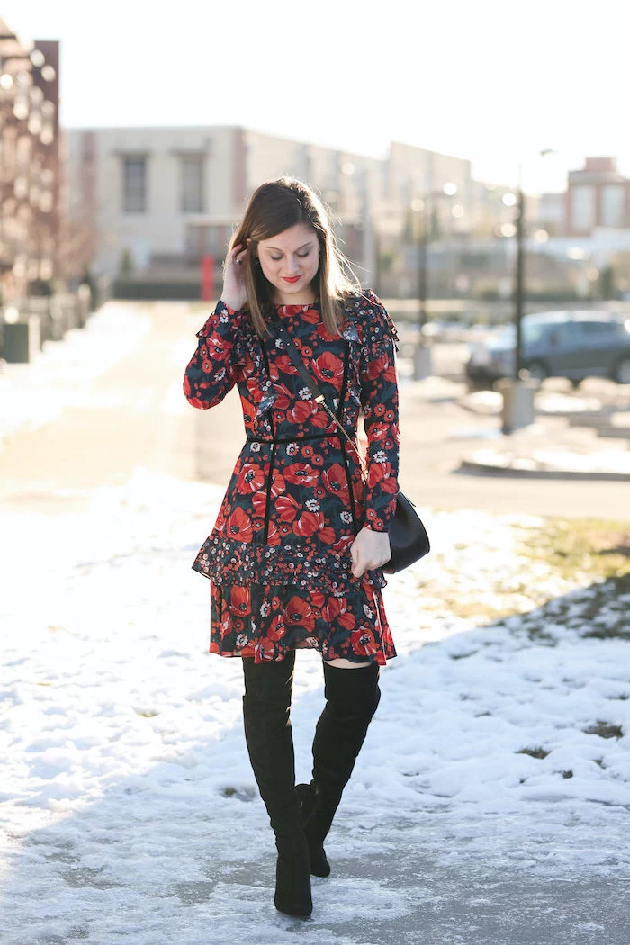 woman wearing red and black floral dress, knee high black velvet boots, valentines day outfits, standing in the snow